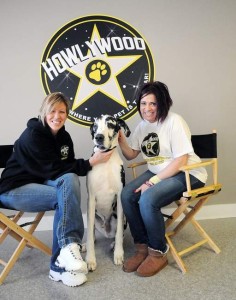 Kelly, dog Hero, and Bianca Bianchi posing at the newly established Howlywood Boarding Kennels near the Finger Lakes.